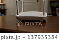 Home wireless internet router with glowing lights on a wooden table. 137935384