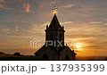 Majestic Church Silhouette Against a Fiery Sunset Sky. 137935399