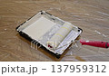 Loading paint roller in tray closeup 137959312