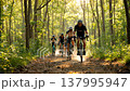 A group of cyclists riding on forest trails and a sun-drenched outdoor adventure. 137995947