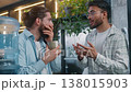 Two diversity men casual business team coworkers talking break pause in office cafe Arabian man talking news Caucasian male shock excited amazed together drinking tea coffee friends partners relaxing 138015903