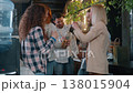 Group Caucasian friends eating cookies in office startup company smiling talking lunch break multiethnic business men women informal casual team colleagues relaxing indoors drinking coffee eat snacks 138015904