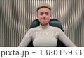 Caucasian stylish trendy woman sitting in chair looking at camera smiling happy cyber futuristic female lady girl look gaze cheerful relaxing sit indoors posing in white futurism studio gaming concept 138015933