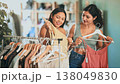 Two young women choosing dresses and tops in store 138049830
