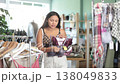 Young woman chooses bra in a fashionable clothing boutique 138049833