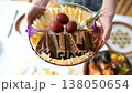 Close-up of traditional Easter plate full of coloured eggs and bread slices. 138050654