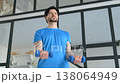 Portrait of active determined sporty fit man exercising dumbbell biceps curl, strengthening upper arm, expressing determination and confidence while working out at home. 138064949