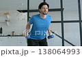 Portrait of active fit man practicing dumbbell triceps kickback exercise, strengthening and toning arm muscles while doing weight training workout indoors. 138064993