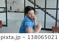 Portrait of active sporty muscular build man practicing shadow boxing workout, training punching techniques, improving upper and lower body muscles at home. 138065021