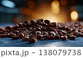 Close-up of roasted coffee beans scattered across a surface, highlighting their rich texture and deep brown color against a blurred glowing background. 138079738