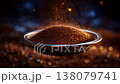 Suspended Coffee Grounds: A Dramatic Visual of Glimmering Brown Particles Floating in Mid-Air Above a Metal Sieve Surrounded by a Soft Background Glow 138079741