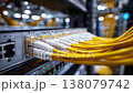 Detailed Close-Up of Network Switch with Numerous Yellow Ethernet Cables Connected, Showcasing Modern Data Center Infrastructure and Connectivity Solutions 138079742