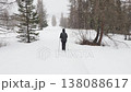 walking under a snowing winter season in dolomites mountains  138088617