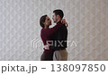 Couple shares a warm embrace in modern indoor setting during evening hours 138097850