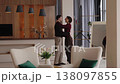 Couple embraces in modern living room during heartfelt reunion 138097855