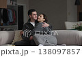 Couple enjoys intimate moment on a cozy couch in a modern living room 138097857