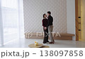 Couple dances in modern interior space with soft lighting and minimal decor 138097858