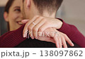 Couple embraces each other and shows their engagement rings 138097862