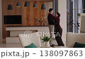 Couple dancing in modern living room with stylish decor and bright ambiance 138097863