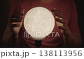 Mysterious fortune teller performing magic ritual with luminous moon shaped crystal ball, hands gesturing gracefully over glowing sphere to predict future in dark interior, close-up, slow motion. 138113956