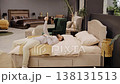Man giving thumbs up testing bed in furniture store 138131513