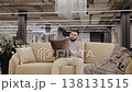 Young man choosing cushion in furniture store 138131515