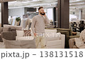 Man talking on phone in furniture store showroom 138131518