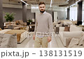 Man browsing furniture store looking for sofa 138131519
