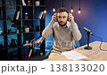 Male podcaster reviewing audio headphones in a home studio, creating digital content for online audience 138133020