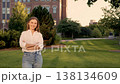 Confident young woman on university campus outdoors, Casual university headshot of young woman with natural pose and friendly smile 138134609