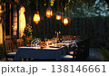 Lanterns illuminating a romantic dinner table in a garden setting 138146661