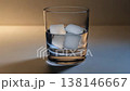 Whiskey pouring into glass with ice on neutral background 138146667