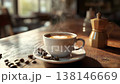 Steaming cup of coffee with latte art and coffee beans on wooden table in cafe 138146669