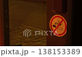 Prohibition symbol on wooden door at night. Night scene with illuminated no smoking sign on wooden door closeup 138153389