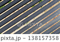 Slow aerial tracking shot of solar panels at an angle 138157358