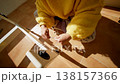 Young Lady Assembling Furniture Smoothly. Woman Tightening Screw On Wooden Chair In Sunlit Cozy Room 138157366