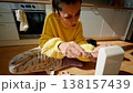 Young Lady Assembling Furniture Smoothly. Woman Tightening Screw On Wooden Chair In Sunlit Cozy Room 138157439