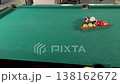 Colorful billiard balls waiting in a wooden triangle rack on a green felt table, ready for the start of a game, with a slow camera pan revealing the entire playing surface and pockets 138162672