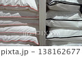 Fresh new white pillows for sleeping stacked high on shelves in a retail home goods store, showcasing a wide selection of bedding options and comfortable sleep accessories for sale 138162677