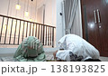Asian husband and wife performing evening prayer at home 138193825