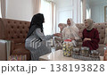 Cozy living room catchup with friends, headscarves and snack jars 138193828