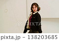 Joyful adolescent girl with curly hair wearing big headphones enjoys music and dances freely in room, concept fun home dance video and youth content for social media. 138203685