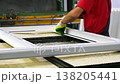 Factory worker assembling a window frame 138205441