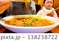 Korean girl eats Jjamppong is a Korean noodle soup with red, spicy seafood 138238722