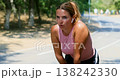 Woman Resting After Outdoor Exercise on Sunny Day 138242330