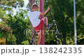 Boy Climbing Rope Structure at Outdoor Playground 138242335