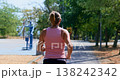 Woman jogging outdoors on a sunny day in a park 138242342