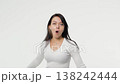 Pretty adult young woman pleasant surprise in white space background copy space 138242444