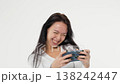 Adult young woman holds phone looks at phone play game white background isolated space 138242447
