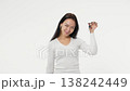Young adult woman holds the keys to buying a car or apartment white background isolated space happy 138242449